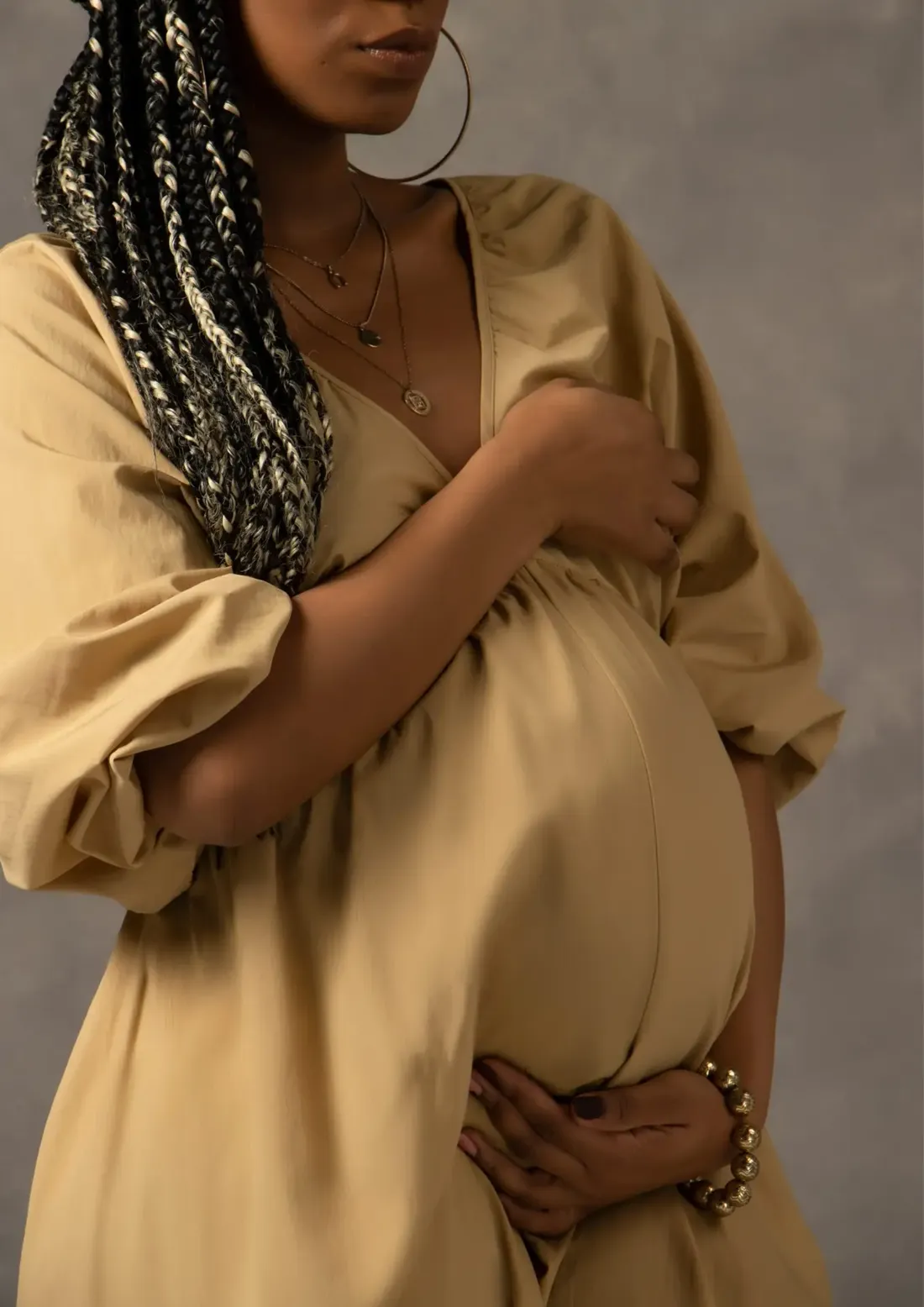 An expectant mother holding her bump